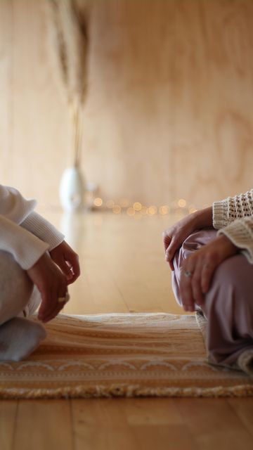 Two women sitting together on a rug, the human coaching at the heart of SANYA